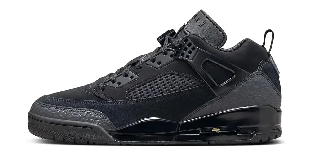 A black sneaker with a chunky sole, featuring a combination of suede and leather materials, and a distinctive midsole design with visible air cushioning.