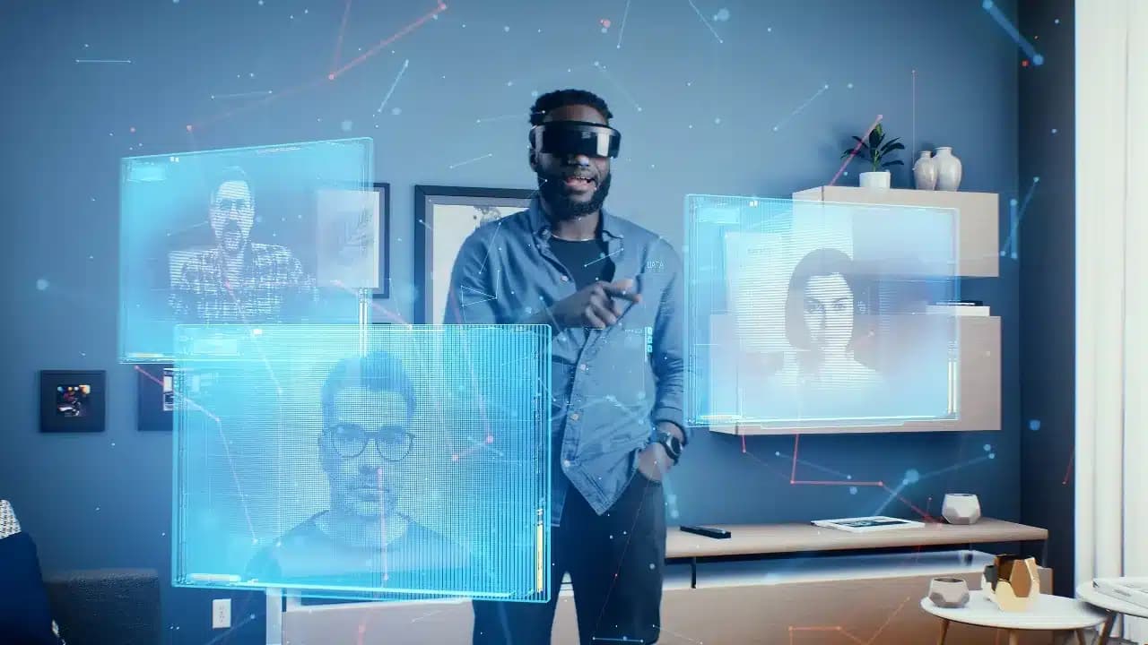 A person wearing virtual reality glasses interacts with multiple floating holographic screens displaying various people in a modern room setting.