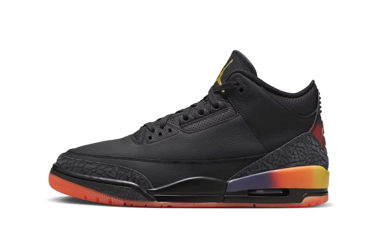 A black sneaker with orange and purple gradient accents on the heel and a textured black midsole featuring an air unit. The outsole is bright orange.