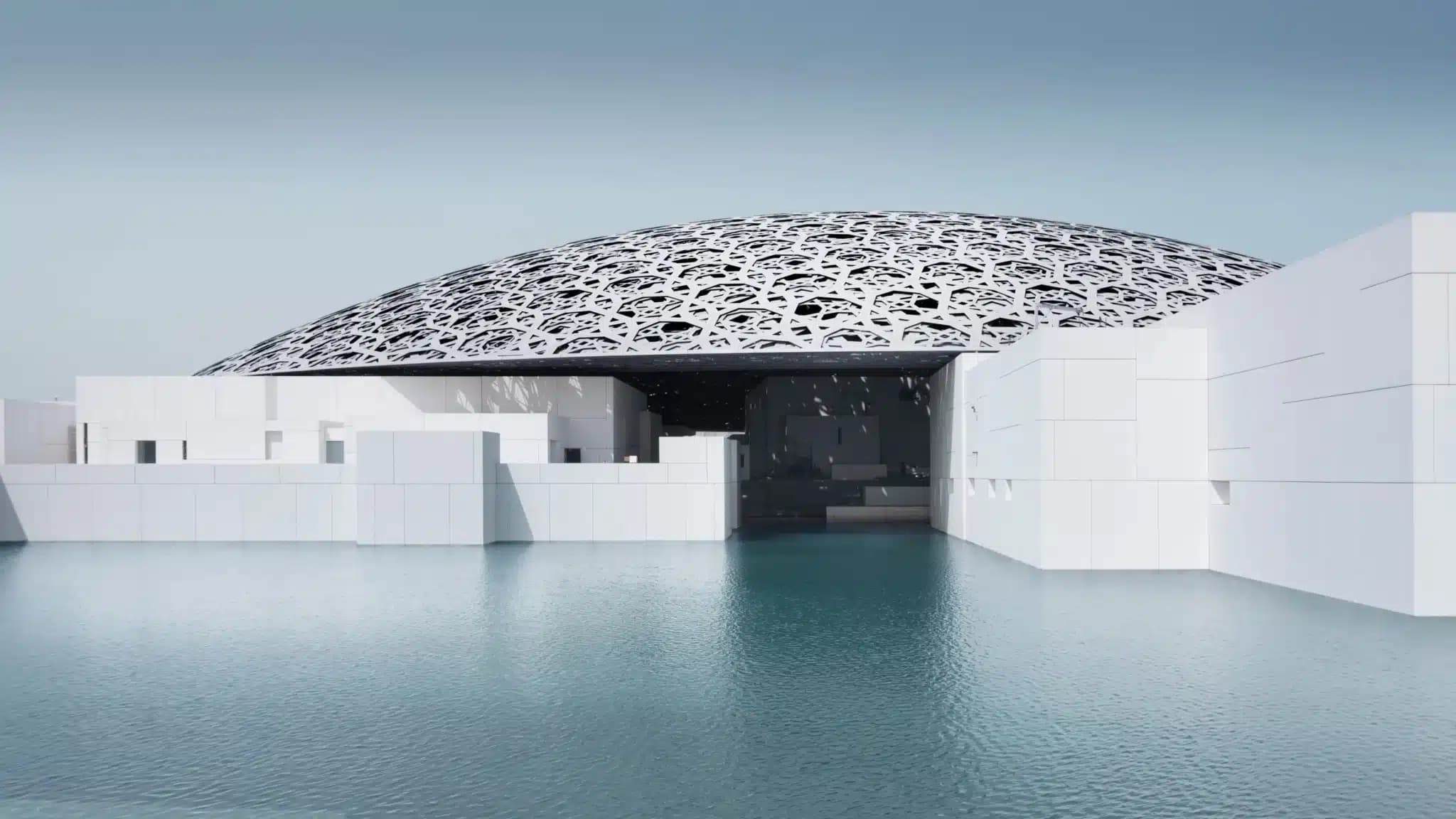 A modern building with a large, intricate dome stands surrounded by water, featuring a pattern that resembles interlocking stars.